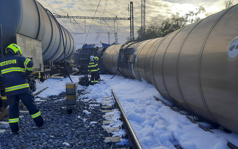Zkušení hasiči z chemičky pomáhají u vlakové nehody s převrácenými cisternami