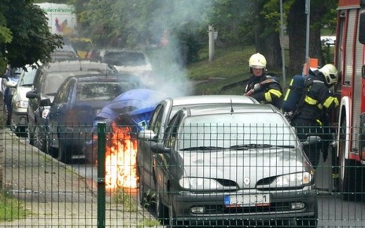 Plameny zachvátily popelnice v Bílině, požár poškodil i fasádu domu a okno